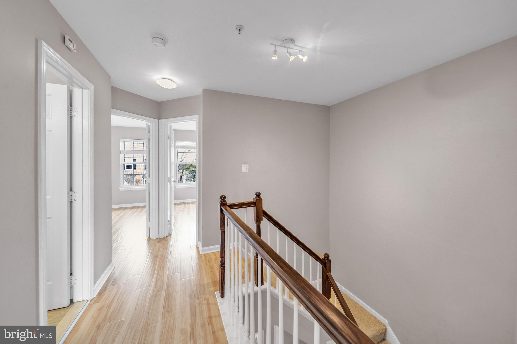 122 Longpoint Way Gaithersburg, MD 20878 - Photo 23 of 37 a view of a hallway with wooden floor and stairs