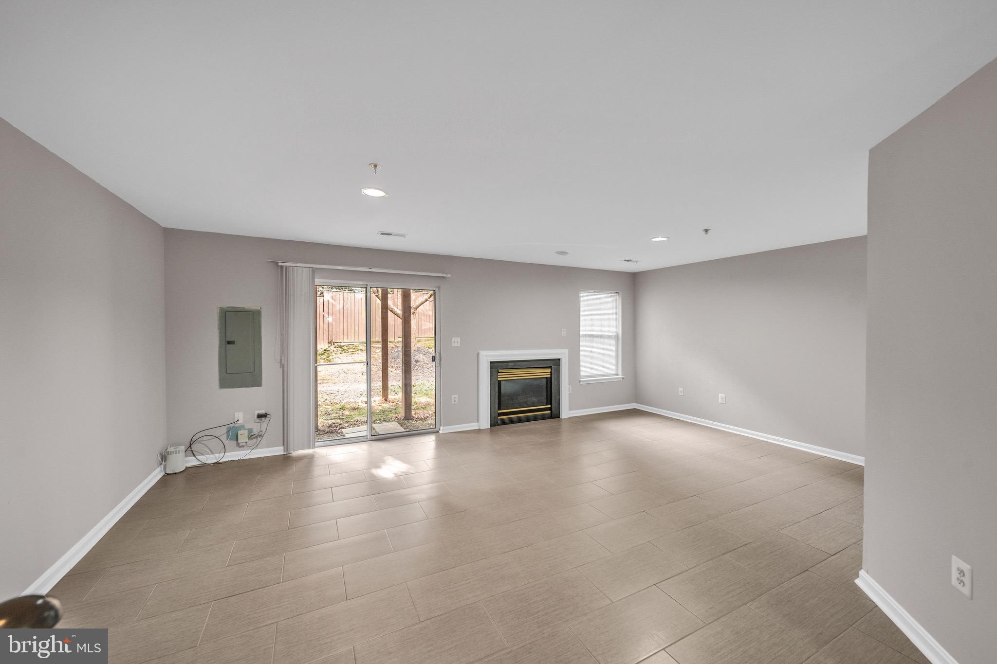 122 Longpoint Way Gaithersburg, MD 20878 - Photo 25 of 37 wooden floor in an empty room with a fireplace