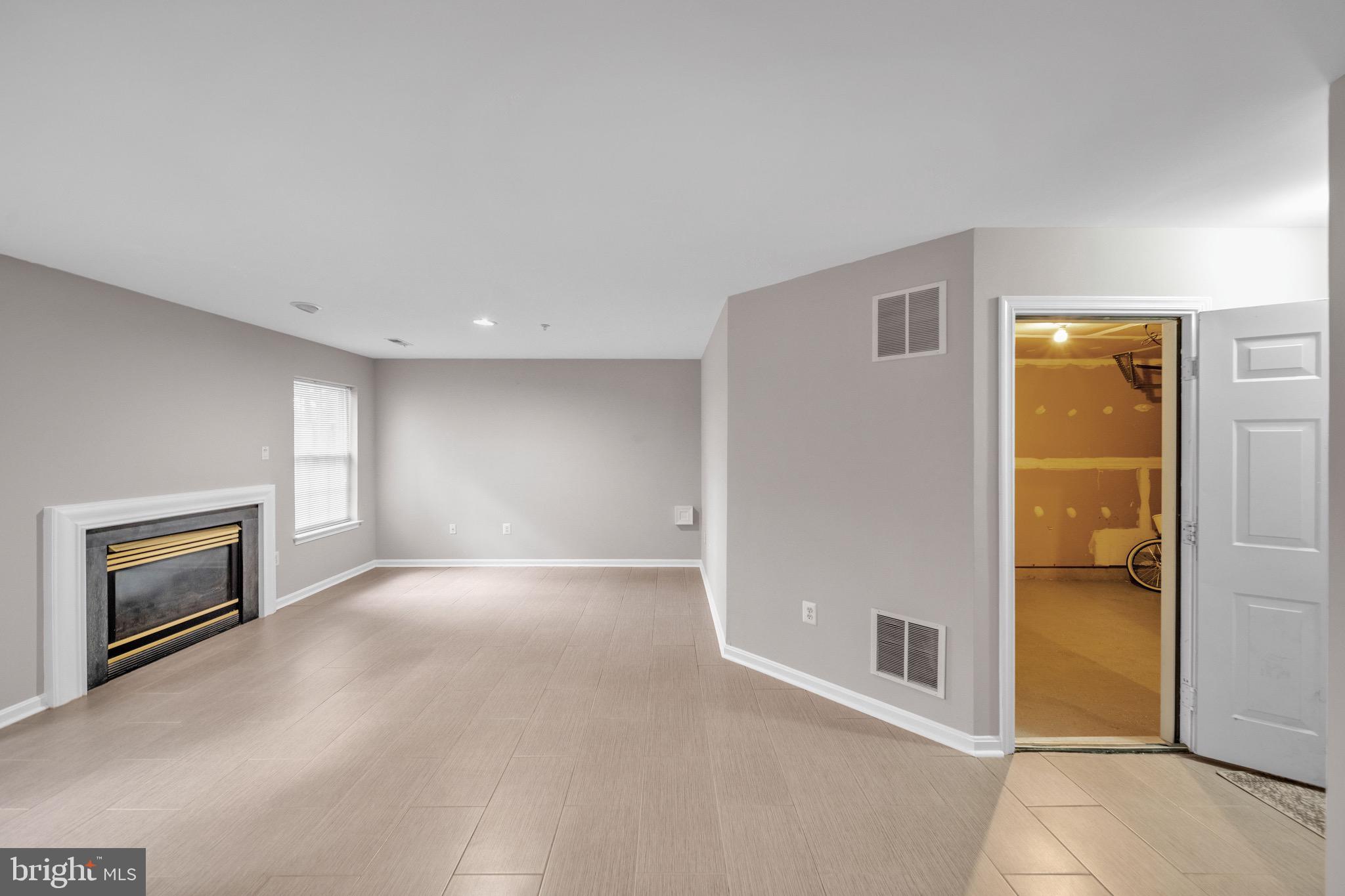 122 Longpoint Way Gaithersburg, MD 20878 - Photo 27 of 37 an empty room with windows and fireplace