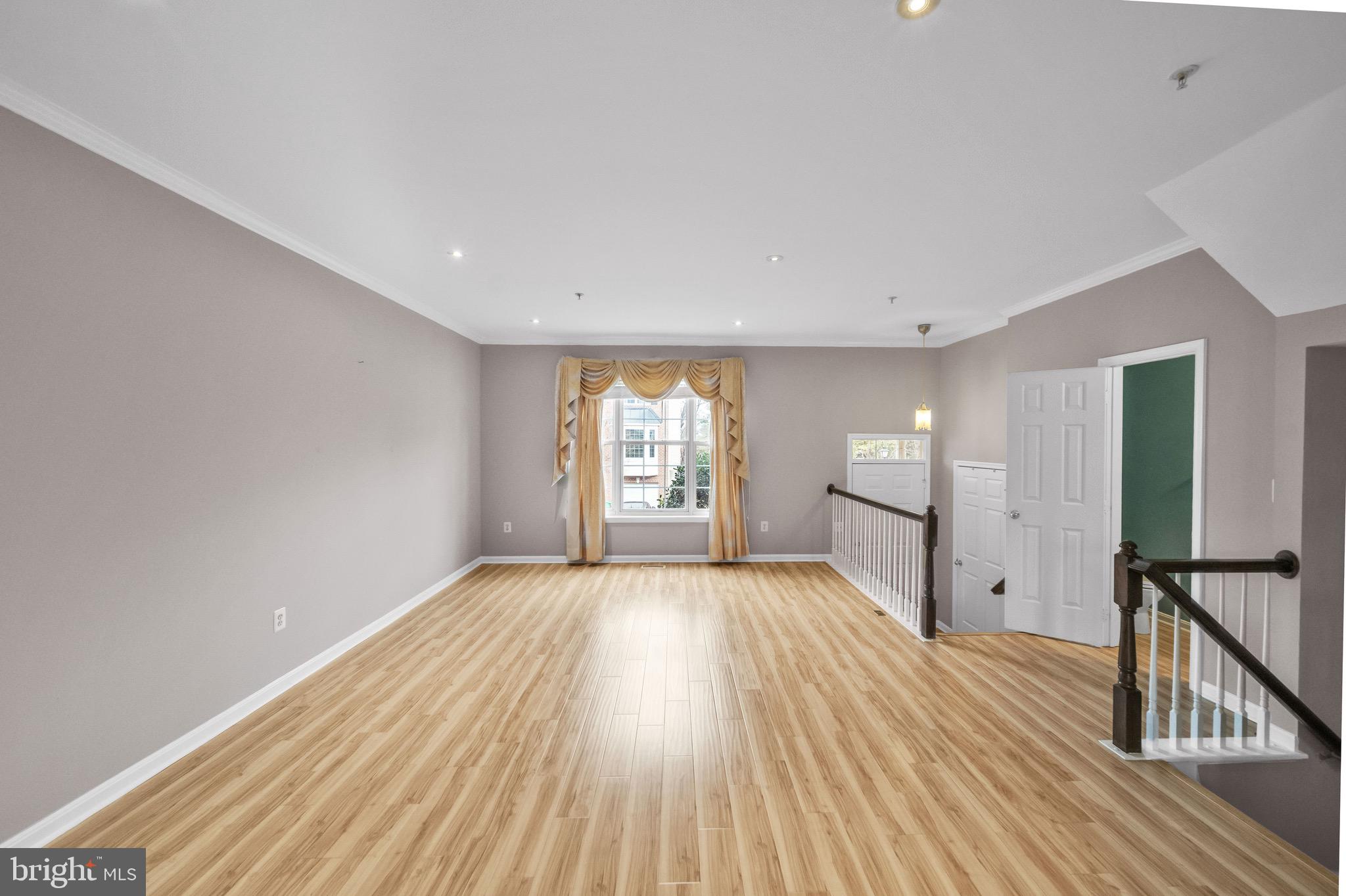 122 Longpoint Way Gaithersburg, MD 20878 - Photo 3 of 37 a view of an empty room with wooden floor and a window