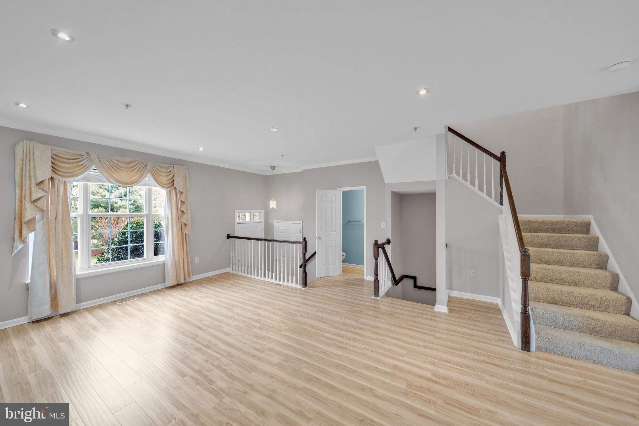 122 Longpoint Way Gaithersburg, MD 20878 - Photo 4 of 37 a view of empty room with wooden floor and fan