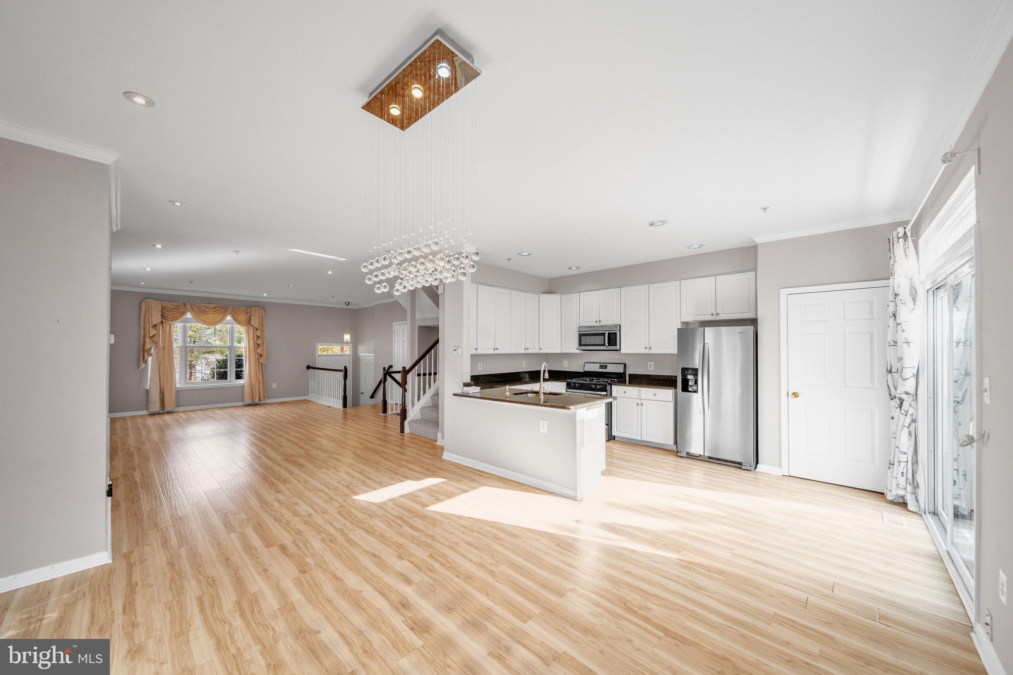 122 Longpoint Way Gaithersburg, MD 20878 - Photo 8 of 37 a large kitchen with cabinets wooden floor and stainless steel appliances