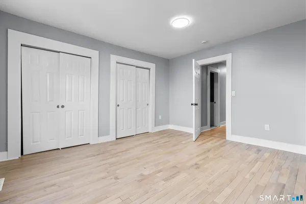 a view of an empty room with wooden floor