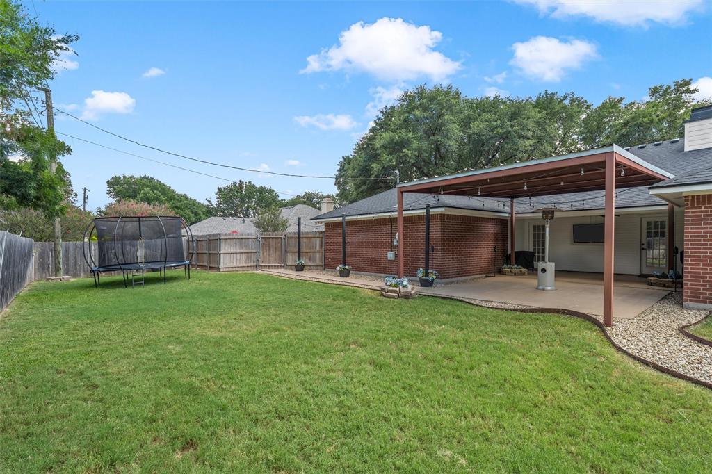 112 Briar Ridge Drive Hewitt, TX 76643 - Photo 14 of 15 Expansive backyard featuring a covered patio with string lighting, a large grass area, and a privacy fence