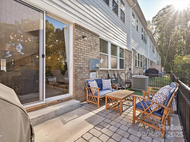 a view of a patio with a table and chairs