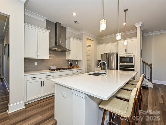 a kitchen that has a lot of cabinets a sink and a stove in it