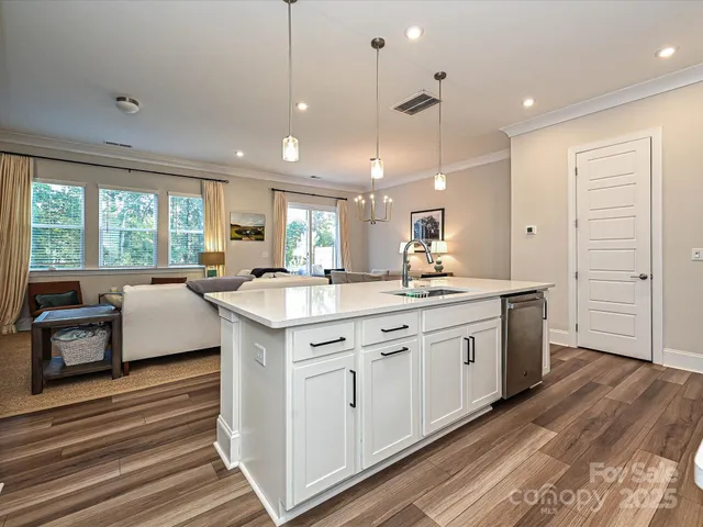 a large kitchen with kitchen island a sink a center island a stove and a window