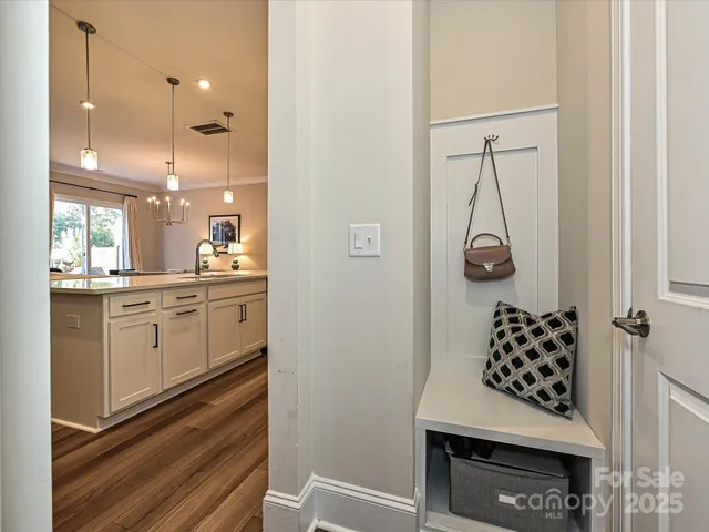 a kitchen with white cabinets and window