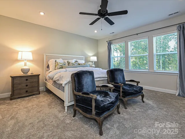 a bed room with a bed and a chair