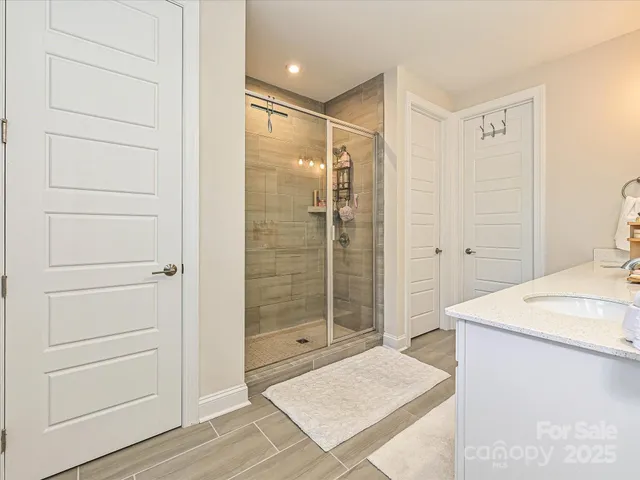 a bathroom with a shower and a sink