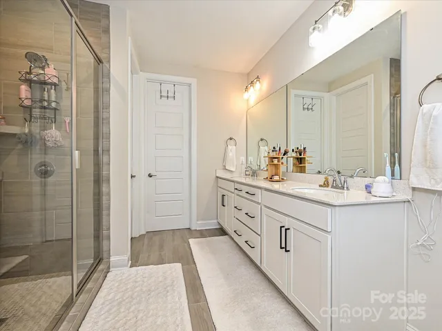 a bathroom with a double vanity sink and mirror