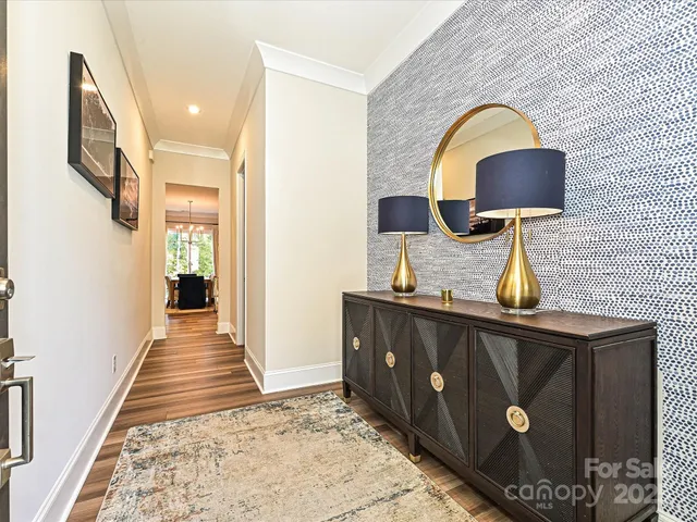 a hallway with a sink and a mirror