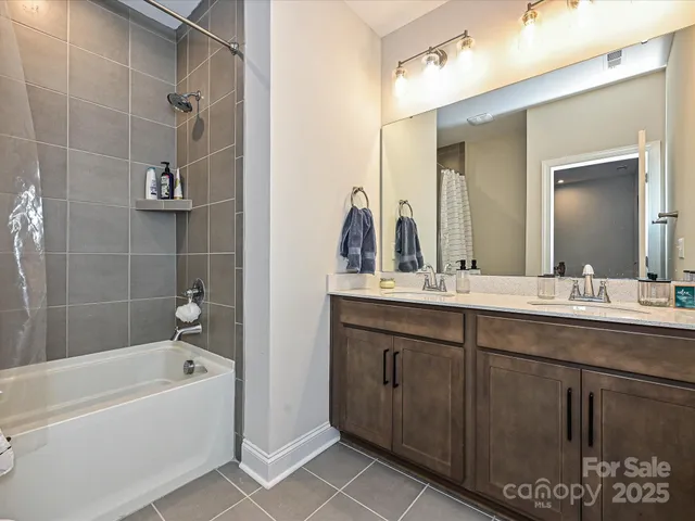 a bathroom with a tub sink and mirror
