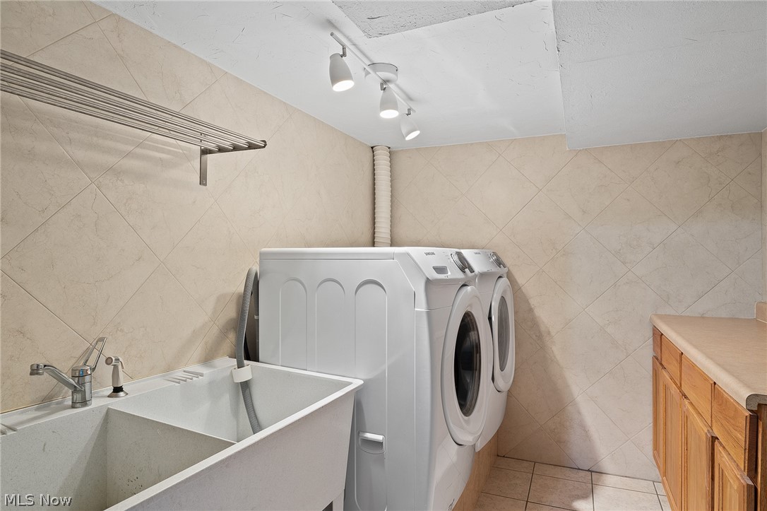 38210 Bainbridge Road Solon, OH 44139 - Photo 28 of 32 Lower level laundry room with wash tub and cupboard/counterspace. Washer and dryer stay