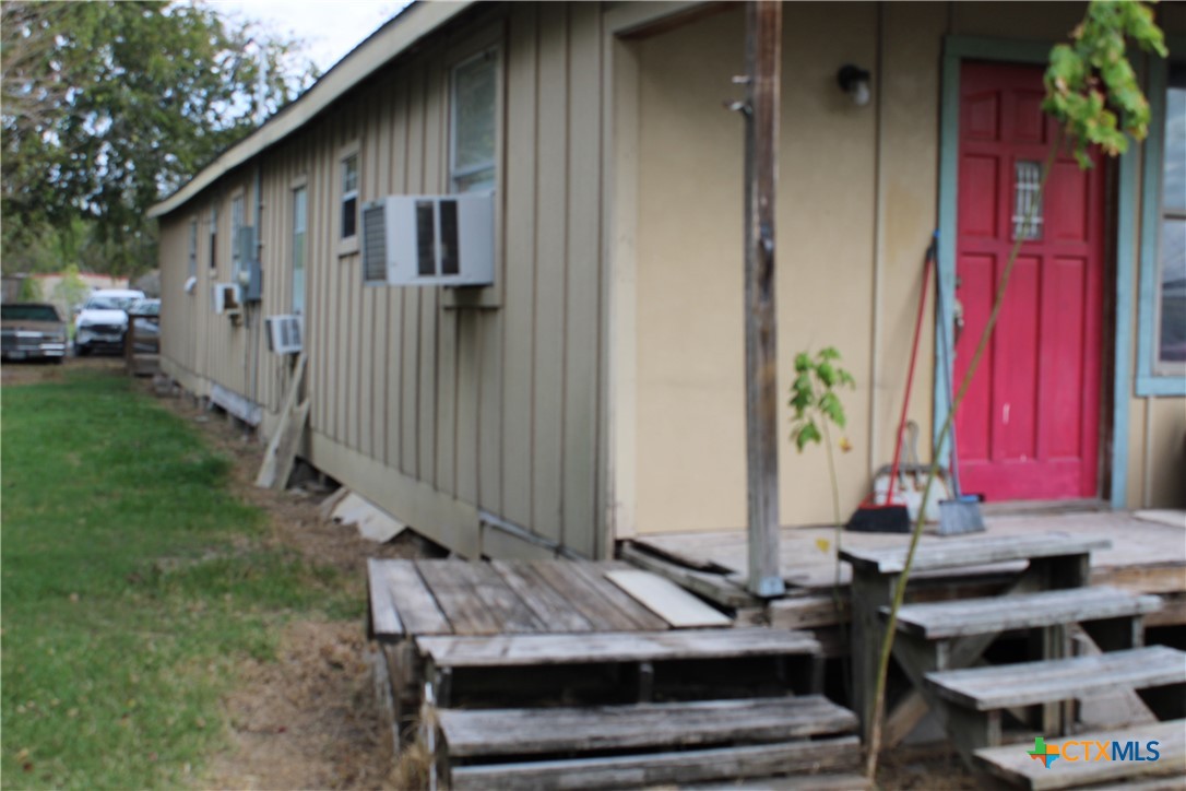 233 Indiana Street Bloomington, TX 77951 - Photo 12 of 16 a front view of a house with a yard