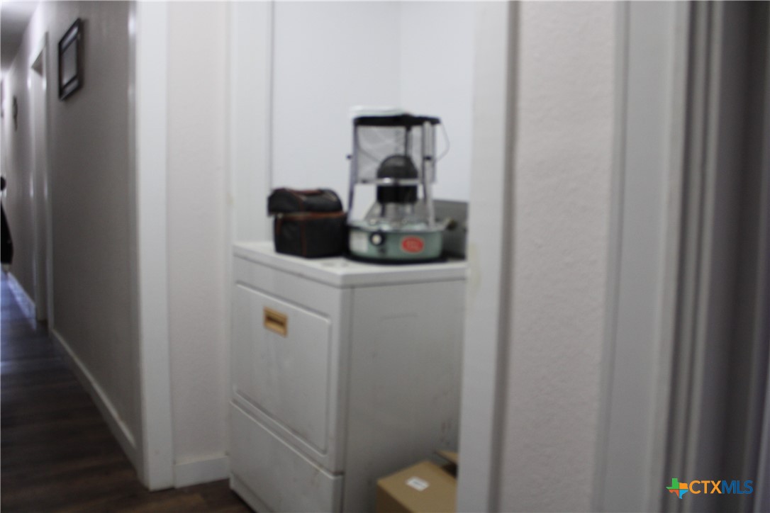 233 Indiana Street Bloomington, TX 77951 - Photo 10 of 16 a bathroom with a sink a toilet and vanity