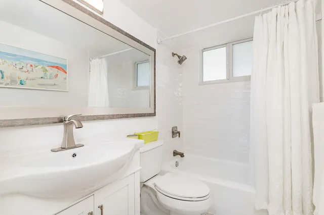 a bathroom with a sink mirror toilet and bathtub