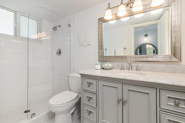 a bathroom with a sink toilet and shower