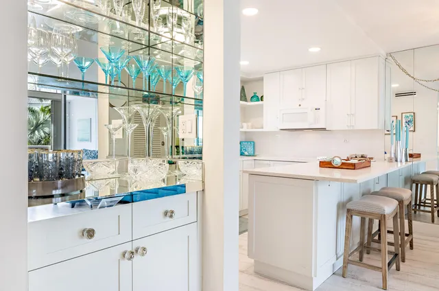 a kitchen with granite countertop white cabinets and white appliances