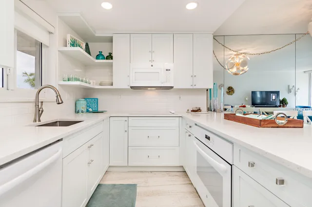 a kitchen with cabinets appliances and a sink