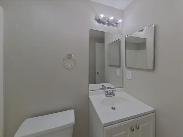 a bathroom with a sink a toilet and mirror