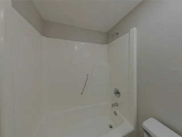 a bathroom with a bathtub and a toilet