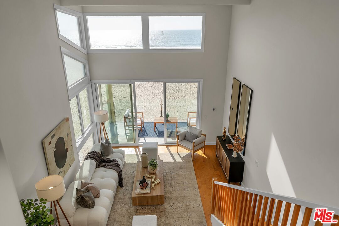 4 Lighthouse Street, Unit 13 Marina del Rey, CA 90292 - Photo 13 of 38 a living room with furniture floor to ceiling window and a flat screen tv