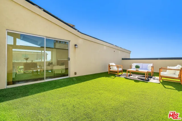 a backyard of a house with table and chairs