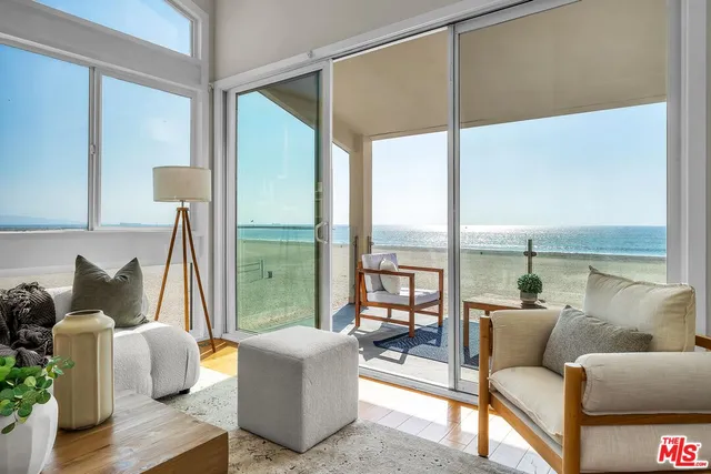 a living room with furniture and a floor to ceiling window