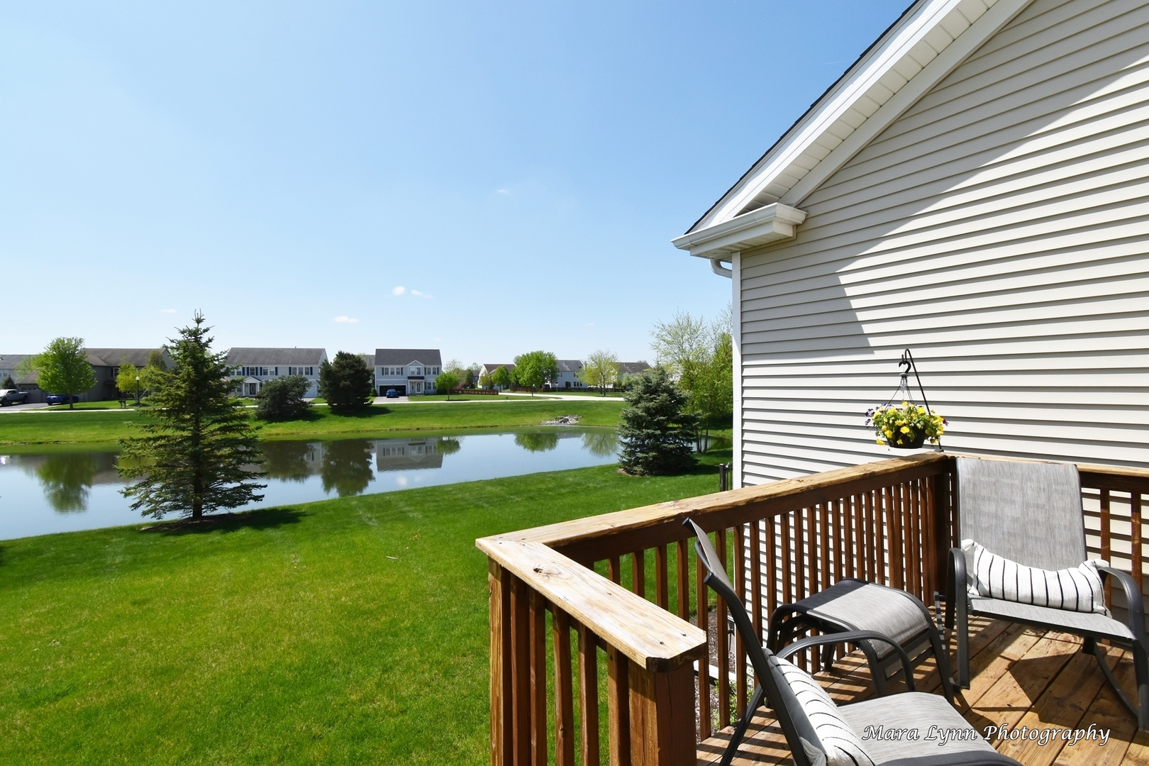 1127 Freedom Road Elburn, IL 60119 - Photo 23 of 29 a view of a deck with a table and chairs with wooden floor