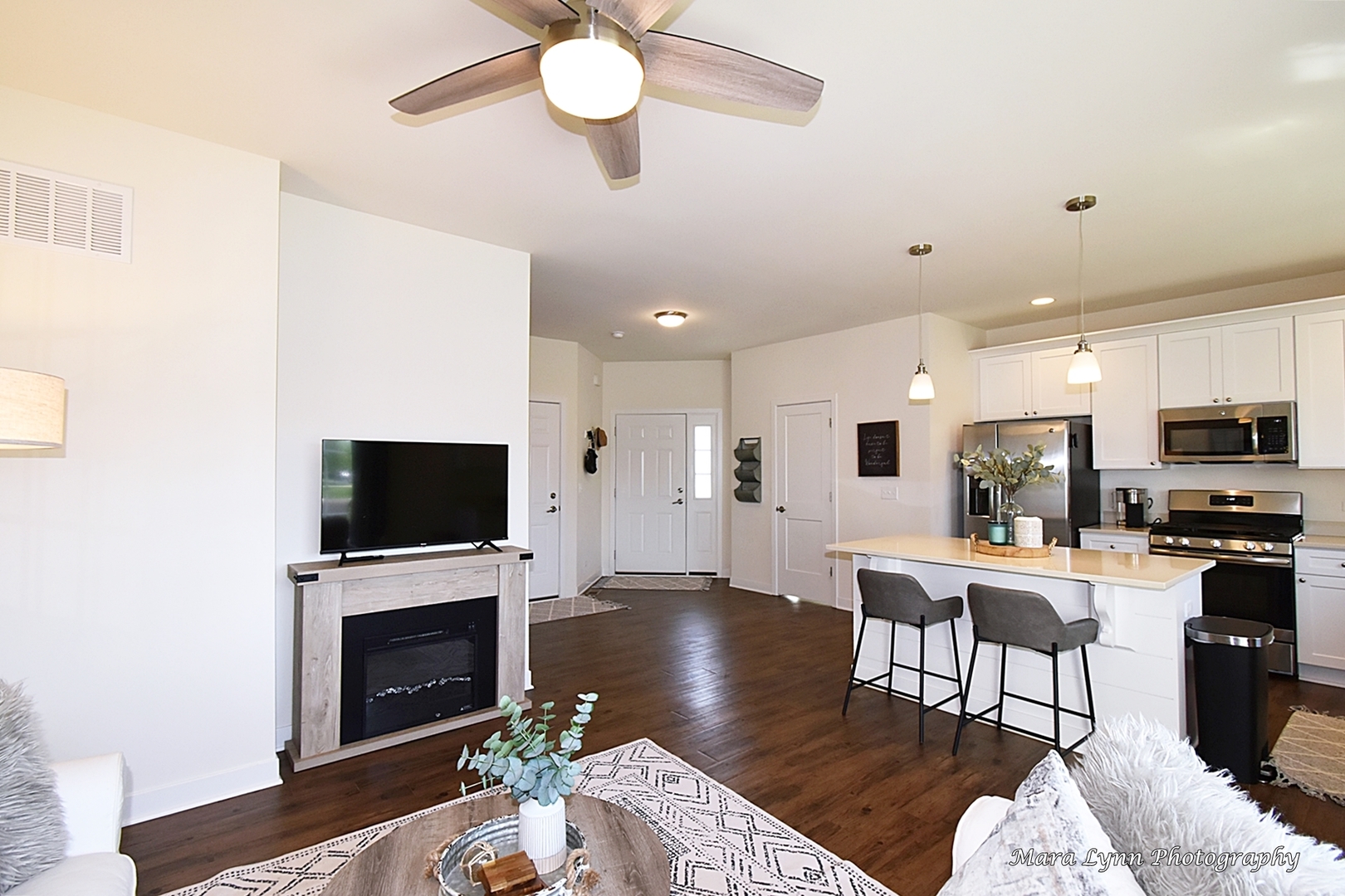 1127 Freedom Road Elburn, IL 60119 - Photo 7 of 29 a living room with furniture a fireplace and a flat screen tv