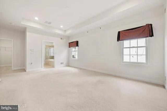 a spacious bathroom with a double vanity sink a toilet and a shower