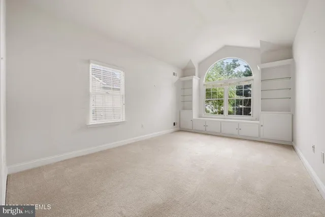 an empty room with windows and windows