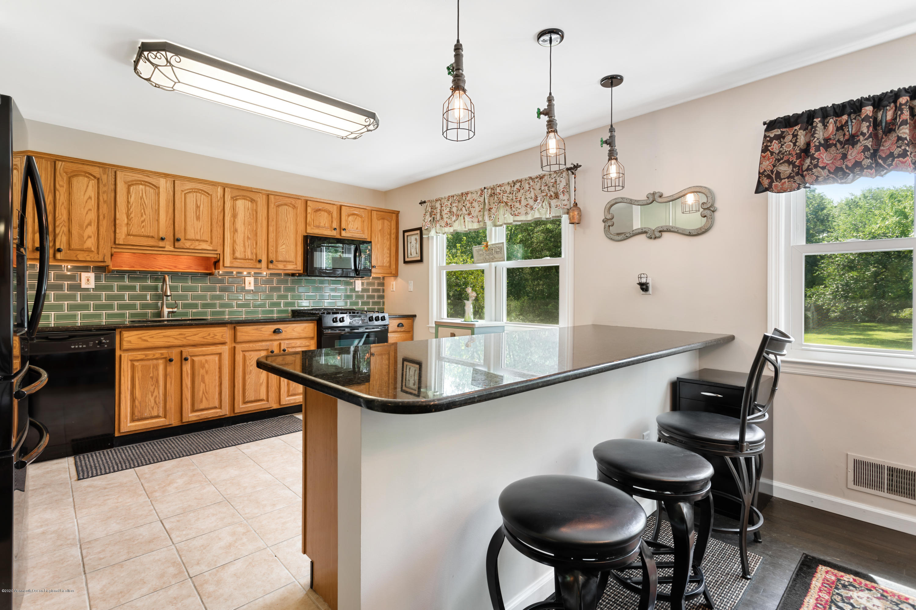 77 East Pleasant Grove Road Jackson, NJ 08527 - Photo 6 of 29 a kitchen with stainless steel appliances a table and chairs in it