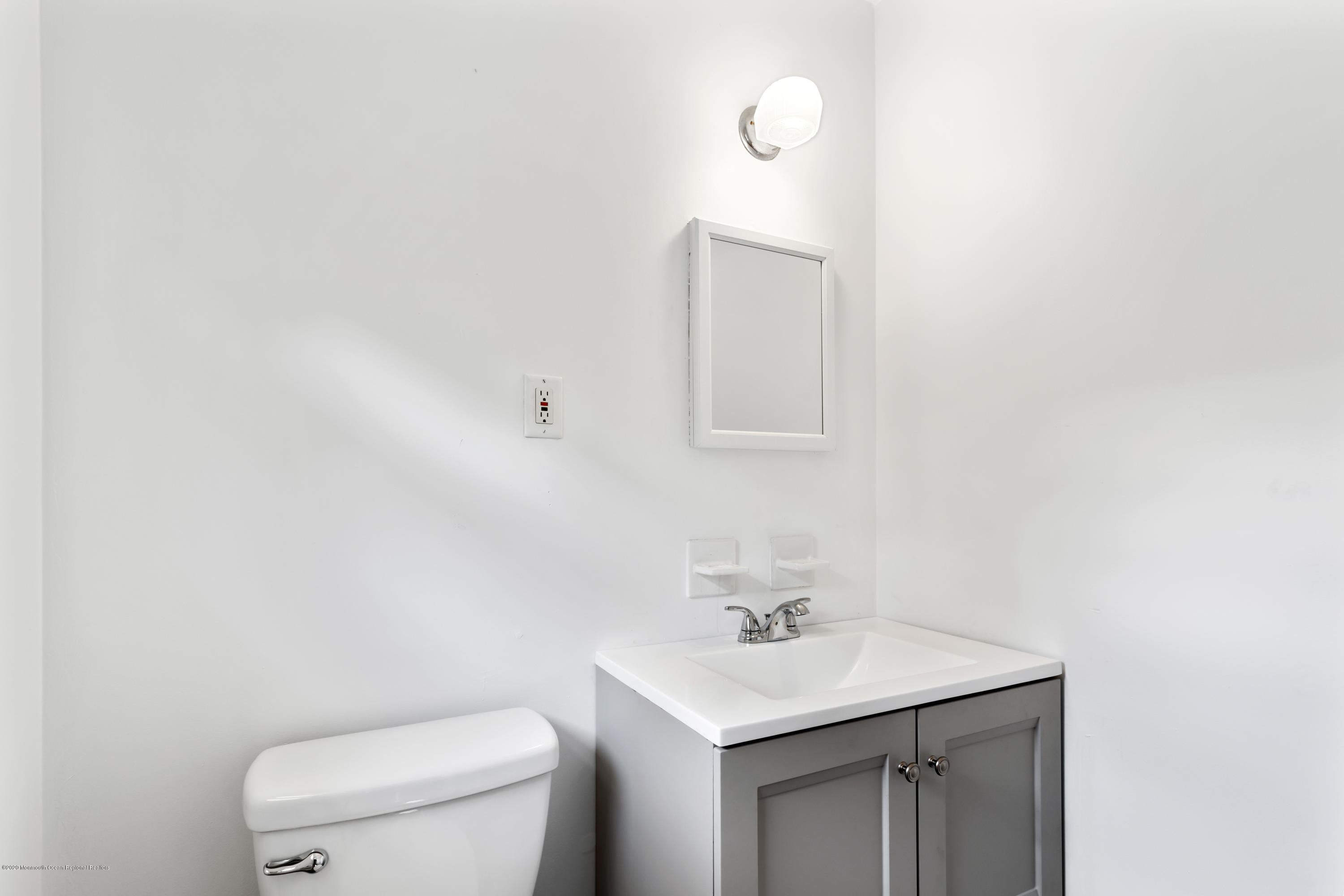 77 East Pleasant Grove Road Jackson, NJ 08527 - Photo 9 of 29 a bathroom with a toilet a sink a mirror and vanity