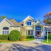 a front view of a house with garden and porch