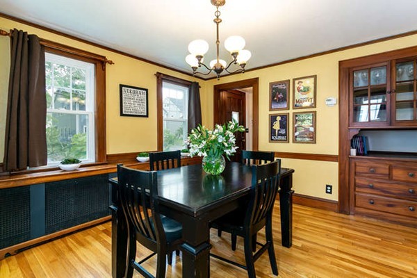 57 Emerson Road Needham, MA 02492 - Photo 4 of 19 a dining room with wooden floor a chandelier a wooden table and chairs
