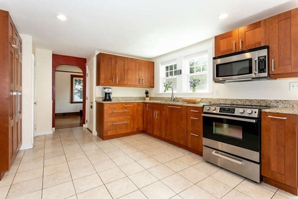 57 Emerson Road Needham, MA 02492 - Photo 6 of 19 a kitchen with stainless steel appliances a sink and a microwave