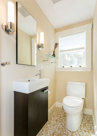 57 Emerson Road Needham, MA 02492 - Photo 8 of 19 a bathroom with a toilet sink a mirror and a window
