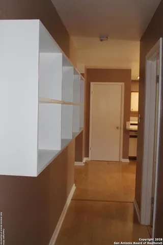 a kitchen with a sink window and cabinets