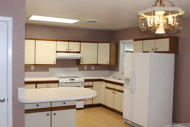 a view of a hallway with a chandelier
