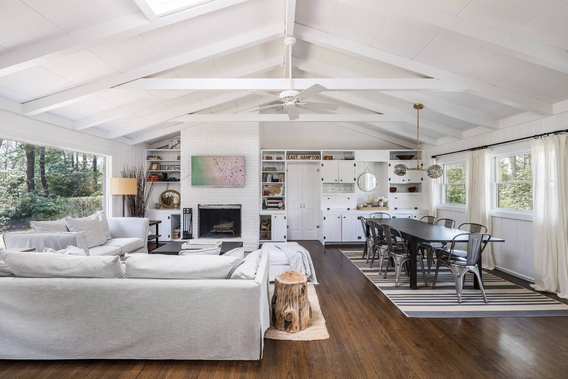 8 Centre Way East Hampton, NY 11937 - Photo 3 of 17 a living room with furniture a fireplace and a dining table with wooden floor
