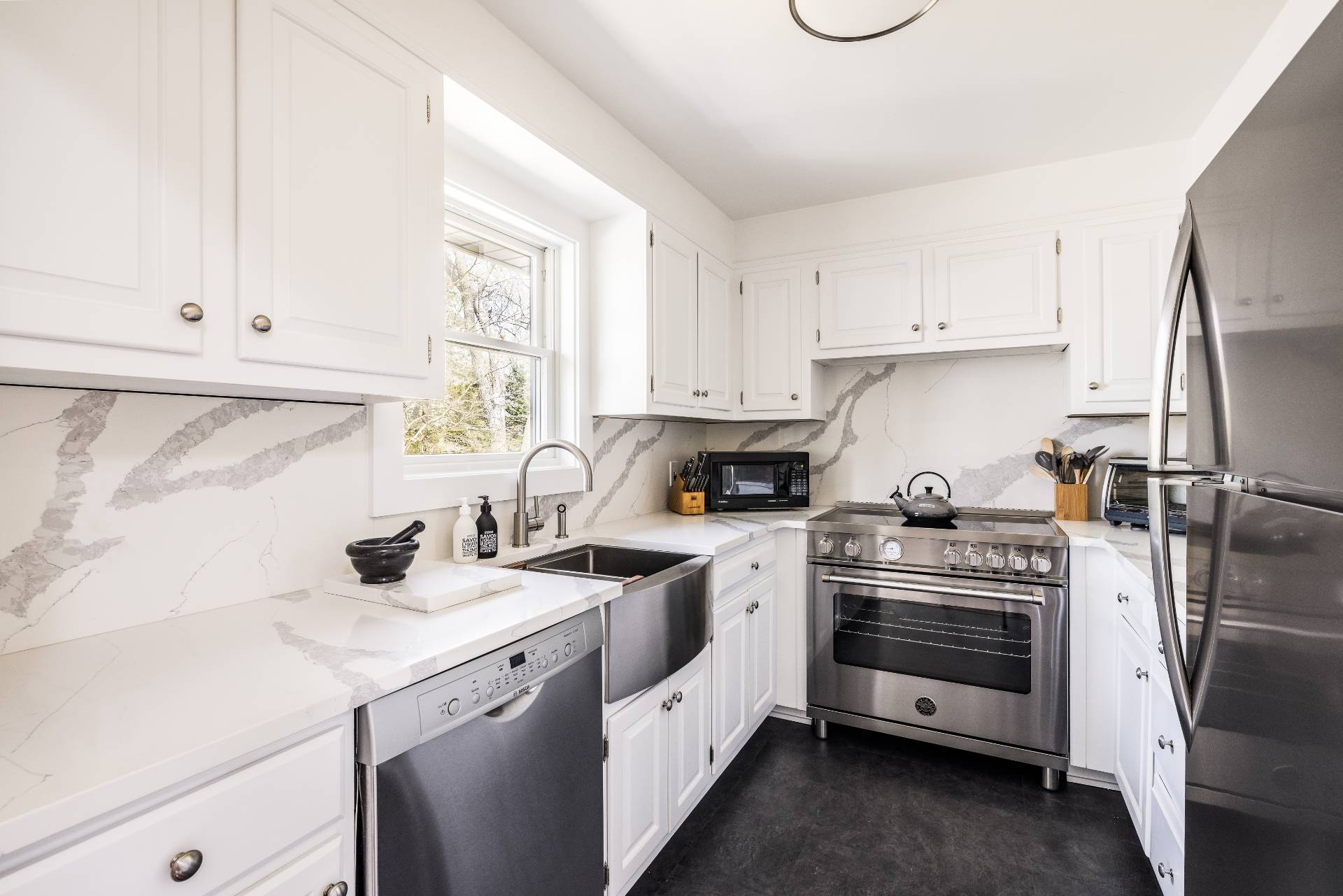 8 Centre Way East Hampton, NY 11937 - Photo 5 of 17 a kitchen with white cabinets and white appliances