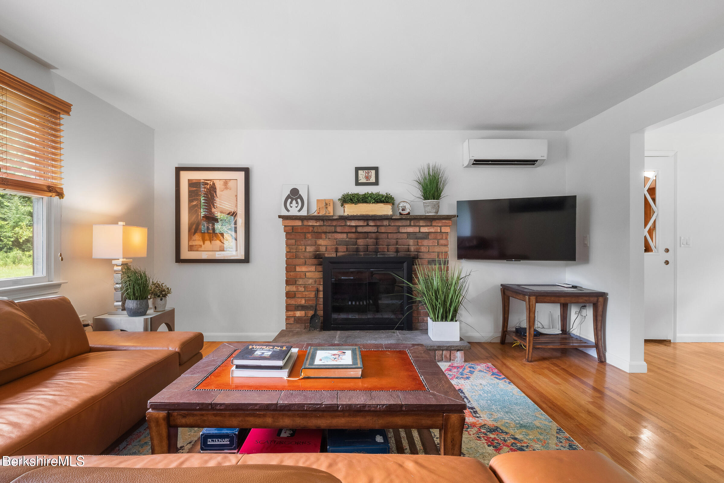 308 Lenox Road Richmond, MA 01254 - Photo 8 of 28 a living room with furniture a flat screen tv and a fireplace