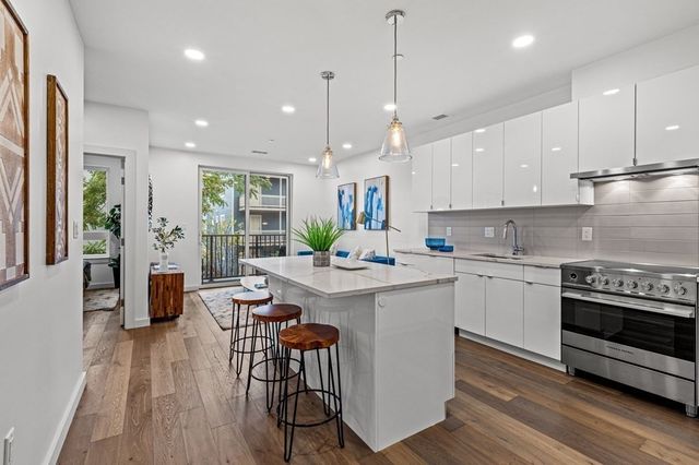 a kitchen with a table chairs stove and microwave