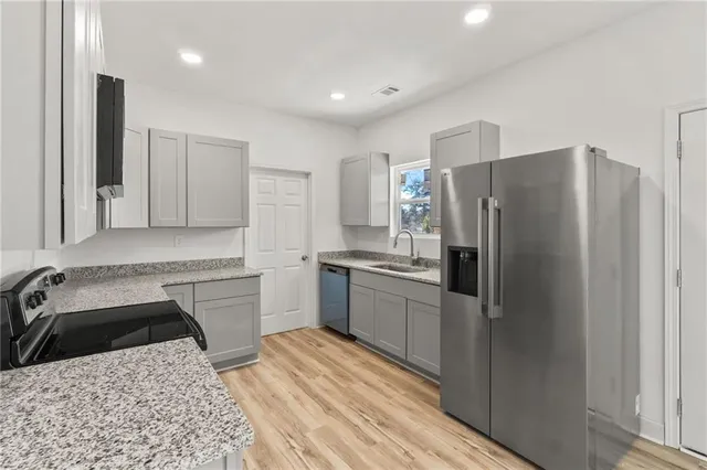 a kitchen with a refrigerator sink and stove