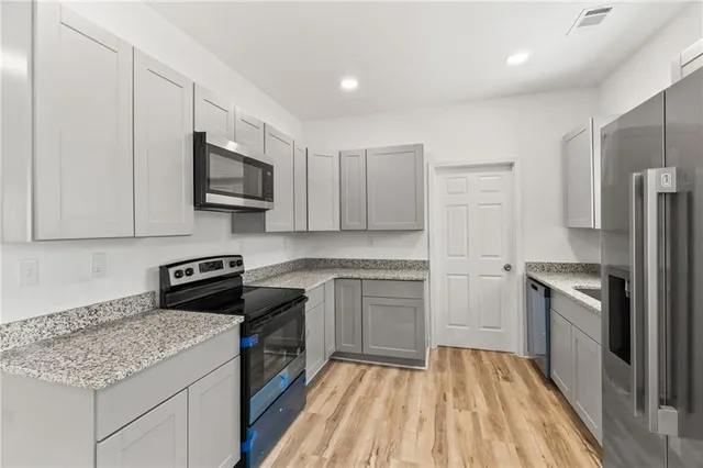 a kitchen with a sink stove and refrigerator