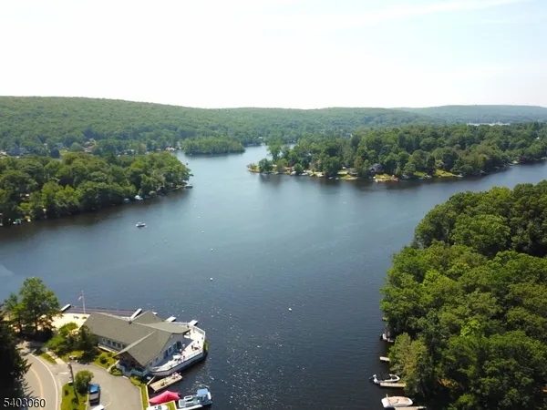 an aerial view of a house with a lake view