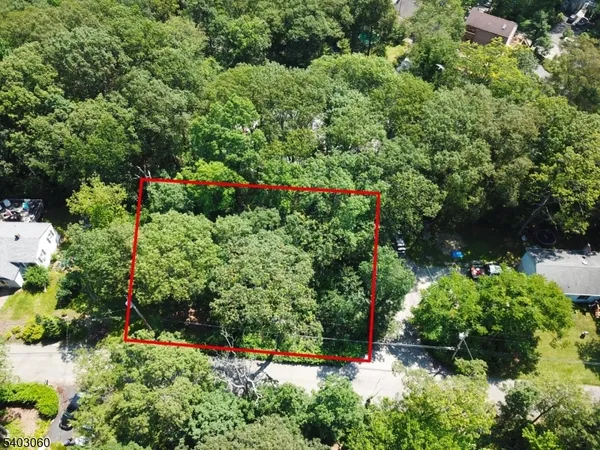 an aerial view of a house with a yard and garden