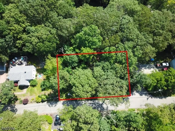 an aerial view of a house with a yard and garden